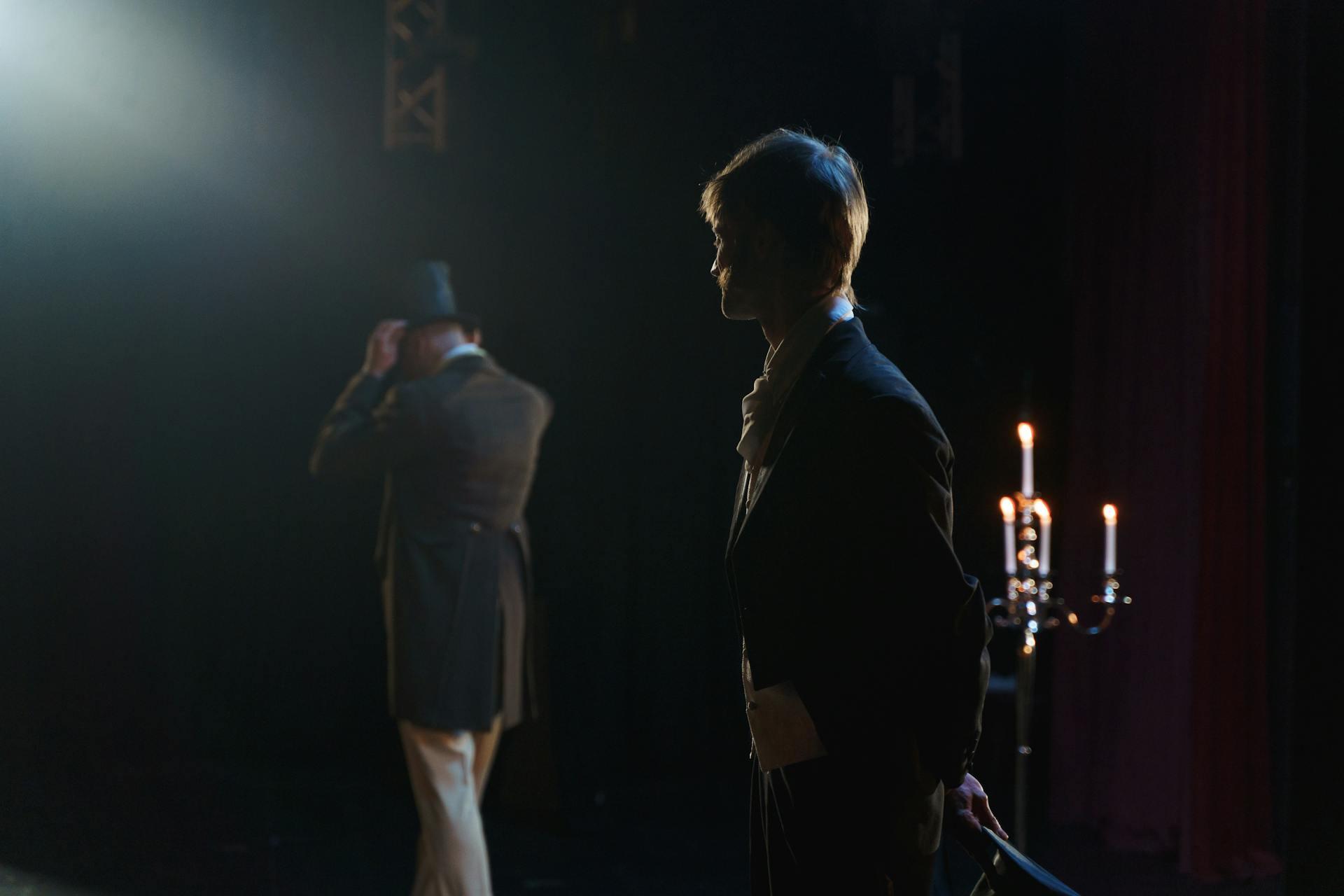 Man in top hat turning away from man in classic clothing